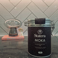 Statera Moka canister on a kitchen counter with a tiled wall background