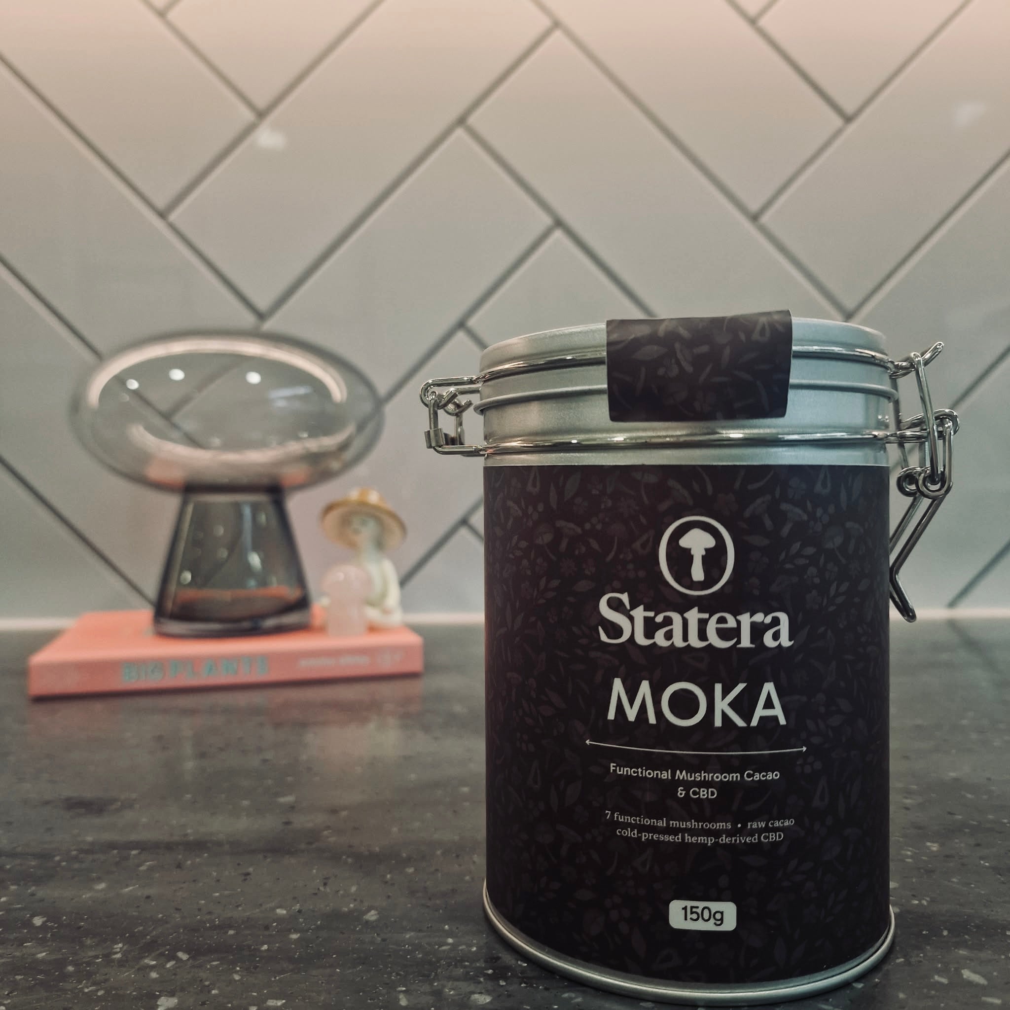 Statera Moka canister on a kitchen counter with a tiled wall background